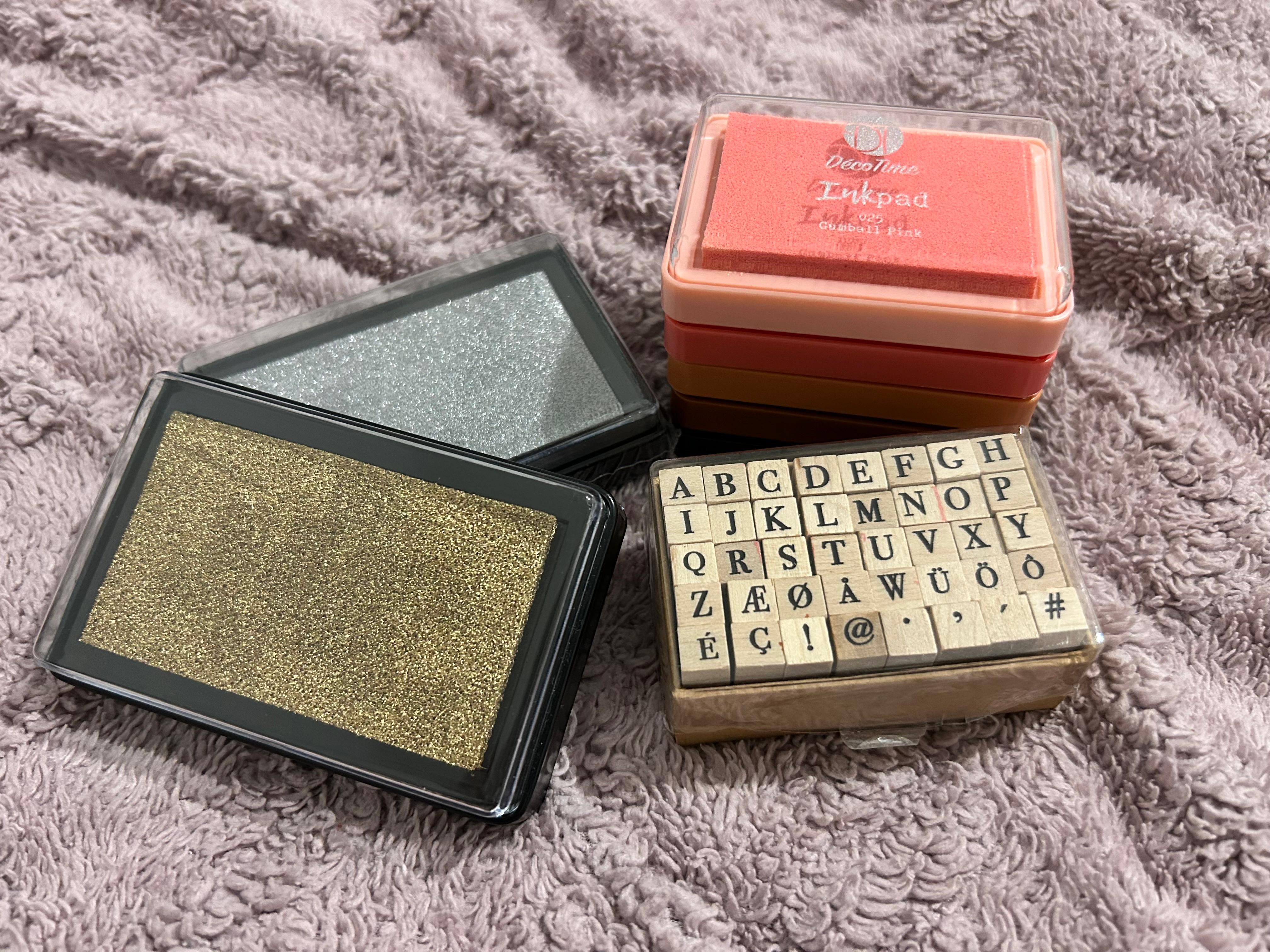An alphabet stamp set with colorful ink pads.